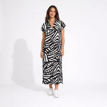Load image into Gallery viewer, Woman wearing a black and white patterned dress on a white background