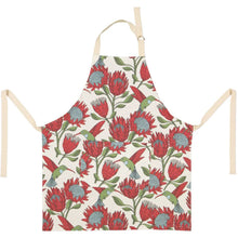 Load image into Gallery viewer, Floral apron with red and green protea & sunbird pattern on a white background