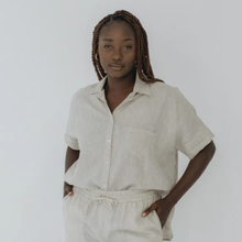 Load image into Gallery viewer, Woman wearing a beige shirt and pants against a white background