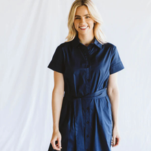 Load image into Gallery viewer, Woman wearing a navy blue dress against a white background