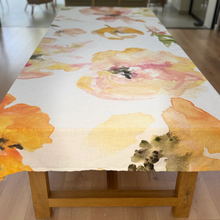 Load image into Gallery viewer, Floral Victoria Verbaan tablecloth on a wooden table with a blurred background