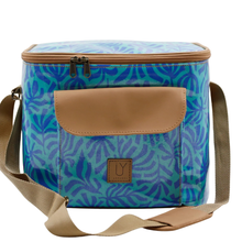 Load image into Gallery viewer, A cool bag with a blue and teal palm leaf pattern, tan faux-leather trim, a front pocket, and a tan shoulder strap on a white background.