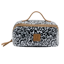 Load image into Gallery viewer, Black & white leopard print toiletry bag with brown handle and logo on a white background