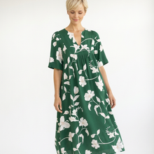 Load image into Gallery viewer, Woman wearing a green floral dress on a white background