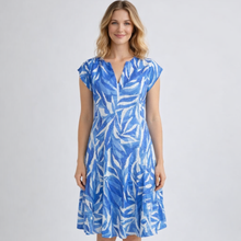 Load image into Gallery viewer, Woman wearing a blue and white patterned dress on a gray background