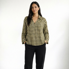 Load image into Gallery viewer, Woman wearing a houndstooth patterned blouse on a white background