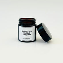 Load image into Gallery viewer, Candle in a black jar with a humorous label on a white background

