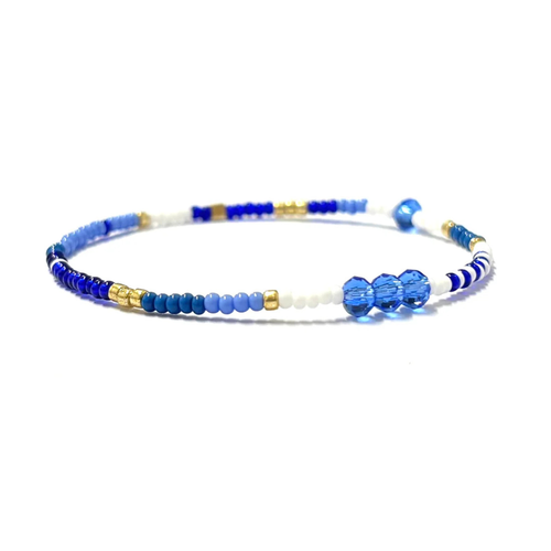 Beaded bracelet with blue, white, and gold beads by Kiki Collection