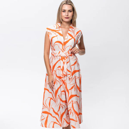 Woman wearing an orange and white patterned dress on a white background