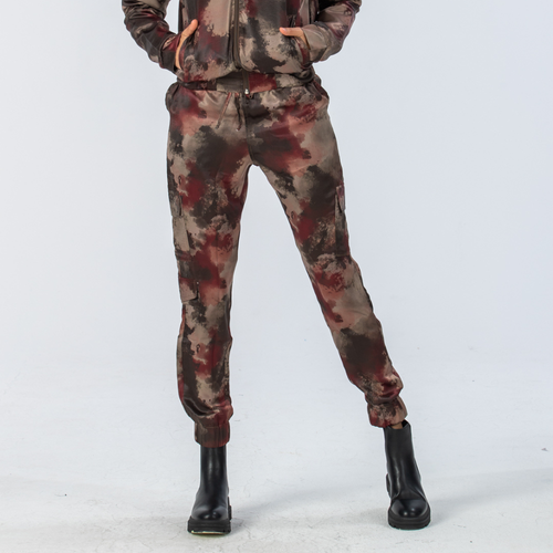 Woman wearing Signature by Des Red Fatigue Boston Cargo pants with black boots 