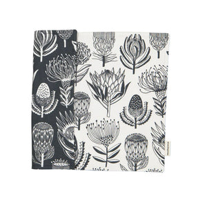 A Love Supreme Floral patterned fabric placemats with grey and white protea design on a white background