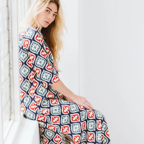 Woman wearing blue, red & white patterned dress