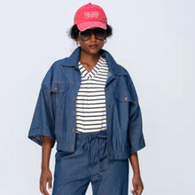 Load image into Gallery viewer, Person wearing a denim outfit with a pink cap on a light gray background
