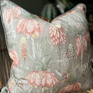 JW Designs Aloe cushion cover with pink flowers on a sage green background with matching piping