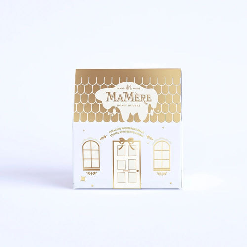 MaMère product packaging with gold and white house design on a white background