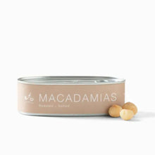 Load image into Gallery viewer, Can of Babylonstoren macadamias with two macadamia nuts on a white background
