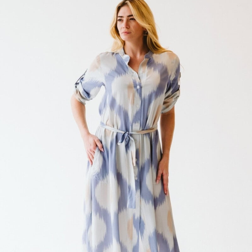 Woman wearing the Trinity Clothing Maggie blue Ikat patterned dress