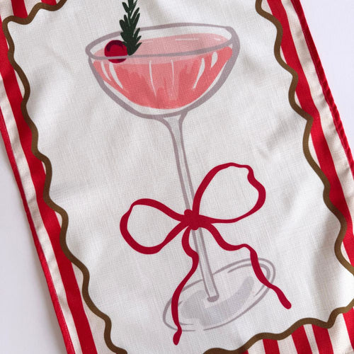 Tea towel with a cocktail glass and bow design on a white background