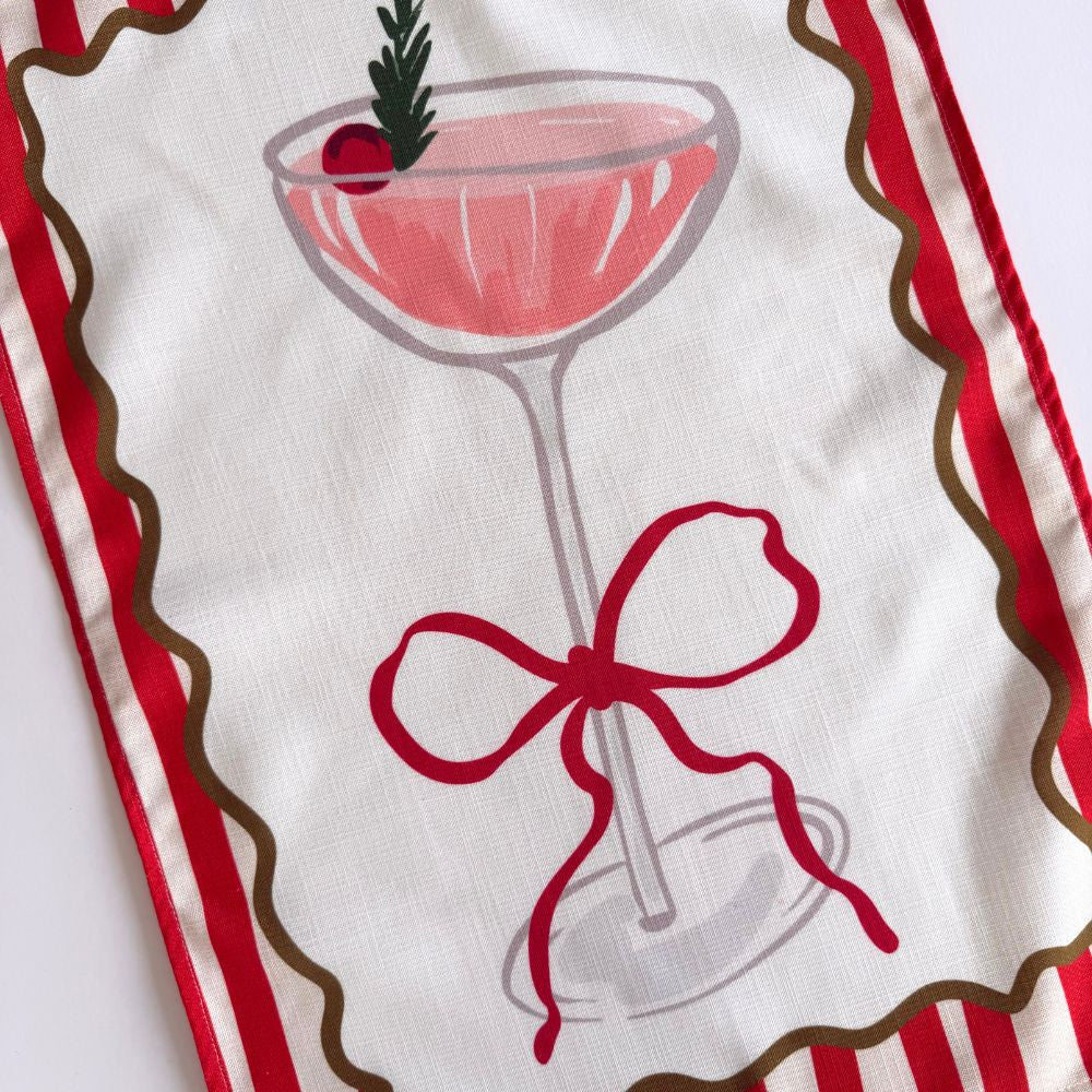 Tea towel with a cocktail glass and bow design on a white background