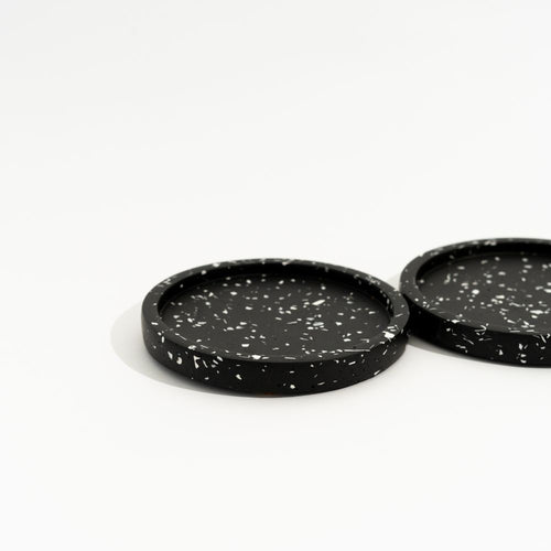 Two black speckled mini trays on a white background