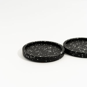 Two black speckled mini trays on a white background