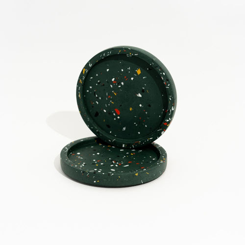 Two dark green speckled mini trays stacked on a white background