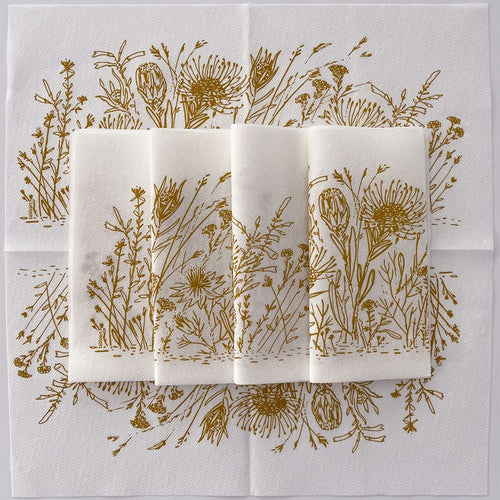 Set of folded napkins with ochre fynbos design on white background