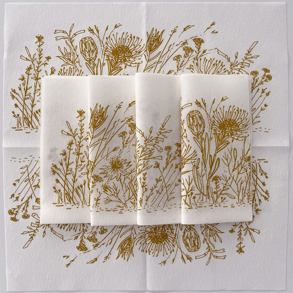 Set of folded napkins with ochre fynbos design on white background