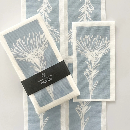 Set of 25 Tableart linen-feel slimline napkins. Blue & white protea pincushion flower design