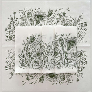 Set of white napkins with sage green fynbos illustrations on a white background