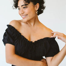 Load image into Gallery viewer, Woman wearing black off-the-shoulder dress
