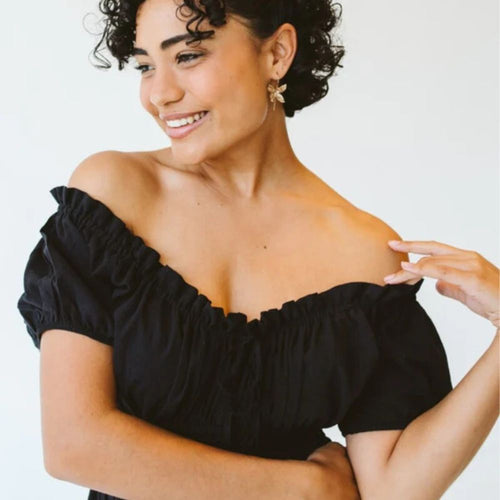 Woman wearing black off-the-shoulder dress
