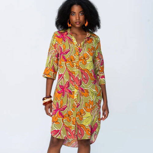 Woman wearing a colorful floral dress on a white background