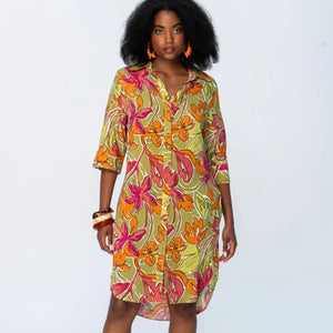 Woman wearing a colorful floral dress on a white background