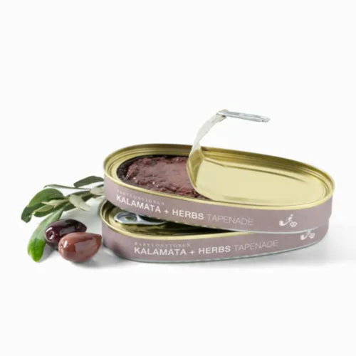 Two tins of Babylonstoren Kalamata + Herbs Tapenade with a white background