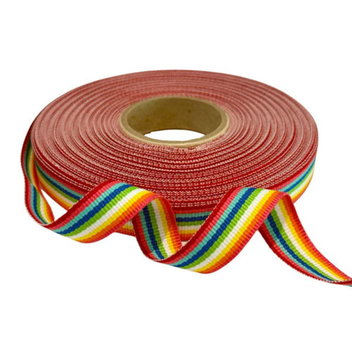 Roll of rainbow striped ribbon with a red background