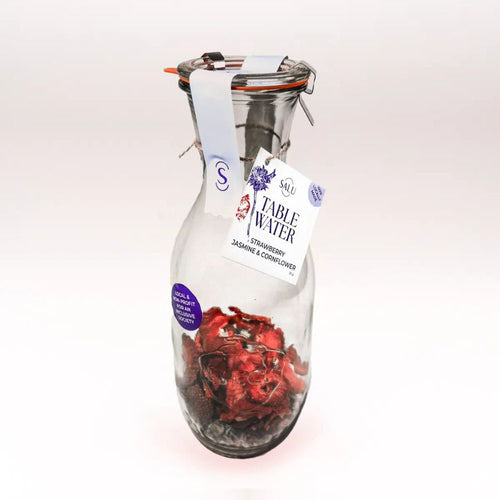 Glass carafe with strawberry, jasmine, & cornflower dried fruit infusion