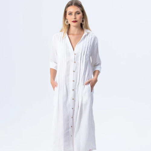 Woman wearing a long white dress with a plain background