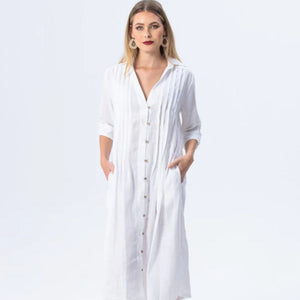 Woman wearing a long white dress with a plain background