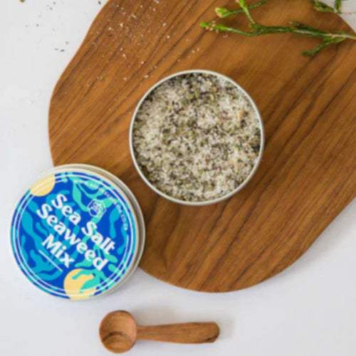 A Love Supreme Sea Salt Seaweed Mix container on a wooden board with a wooden spoon