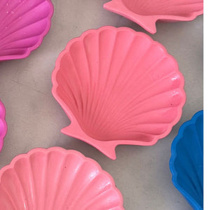 Pink shell-shaped trinket tray on a grey surface