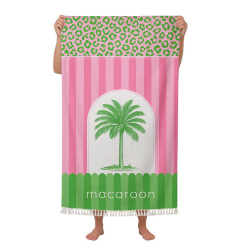 Towel with pink and green design featuring a palm tree and 'macaroon' branding.