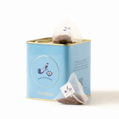 Tea packaging with a tea bag and loose tea on a white background