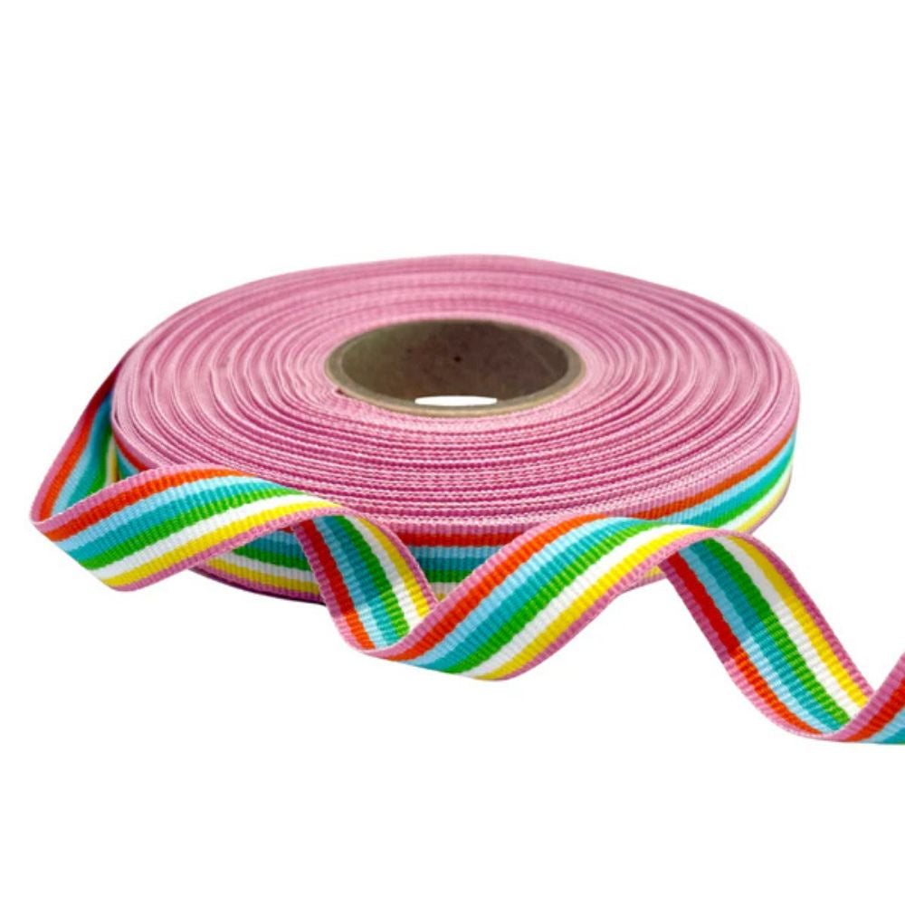Roll of pink ribbon with a colorful stripe on a white background