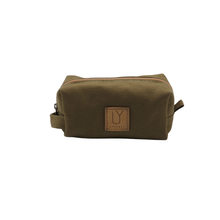 Load image into Gallery viewer, Green toiletry bag with a brown leather patch on a white background
