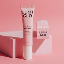 Load image into Gallery viewer, Lumi Glo eye cream tube and packaging on a pink background
