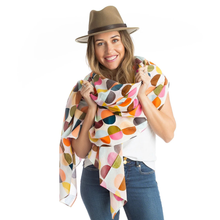 Load image into Gallery viewer, Woman wearing a colorful patterned scarf and a hat on a white background
