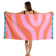 Load image into Gallery viewer, Woman holding a colorful towel with pink and orange wavy patterns on a white background
