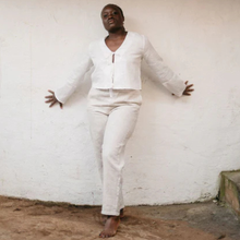 Load image into Gallery viewer, Person wearing a white outfit standing against a white wall.
