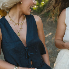 Load image into Gallery viewer, Woman wearing a deep neckline top with gold necklaces outdoors

